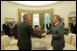 President George W. Bush meets with the Prime Minister David Oddsson of Iceland in the Oval Office Tuesday, July 6, 2004. White House photo by Eric Draper.
