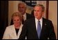 President George W. Bush enters with Sally and Senator John Danforth before the swearing-in ceremony for Senator Danforth as the new representative of the United States to the United Nations in the Eisenhower Executive Office Building on July 1, 2004. White House photo by Paul Morse