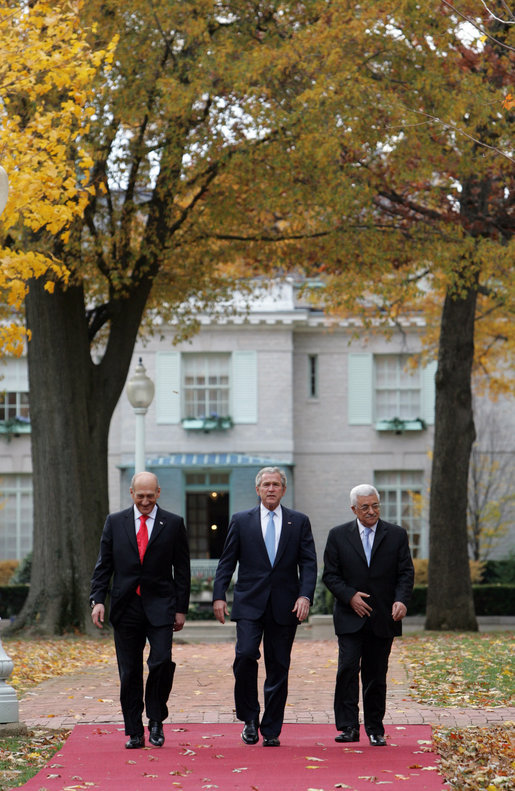 President George W. Bush is flanked by Prime Minister Ehud Olmert, left, of Israel, and President Mahmoud Abbas of the Palestinian Authority as they walk Tuesday, Nov. 27, 2007, from the Buchanan House on the grounds of the U.S. Naval Academy in Annapolis, Maryland, to Bancroft Hall during the Annapolis Conference. The leaders agreed to immediately resume Mideast peace talks. White House photo by Chris Greenberg