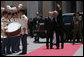 President George W. Bush waves as he stands with Italy's Prime Minister Romano Prodi Saturday, June 9, 2007, after arriving at Chigi Palace in Rome. White House photo by Chris Greenberg