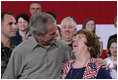 President George W. Bush embraces Joy Enders, president of the 167th Airlift Wing Family Readiness Group, Wednesday, July 4, 2007, during a Fourth of July visit with members of the West Virginia Air National Guard 167th Airlift Wing and their family members in Martinsburg, W. Va. President Bush thanked Enders and members of her organization for their mission to care for the families of deployed Guard members. White House photo by Chris Greenberg