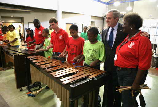 President George W. Bush listens as kids at the Boys and Girls Club of South Central Kansas-21st Street Club play "Hail to the Chief" during his visit Friday, June 15, 2007, to Wichita. White House photo by Eric Draper