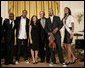 President George W. Bush thanks entertainers, from left to right, KEM, Tourie Escobar, Karina Pasian, Damien Escobar and Miss USA Rachel Smith on stage Friday, June 22, 2007 in the East Room of the White House, for their participation in a celebration of Black Music Month at the White House. White House photo by Eric Draper