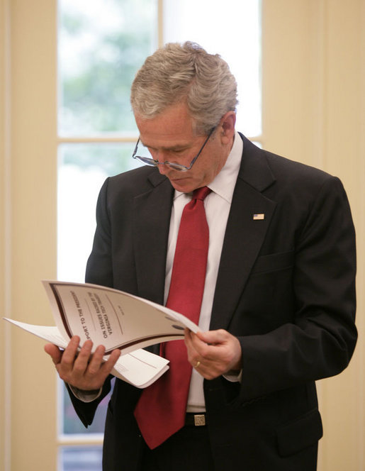 President George W. Bush reads the Report to the President on Issues Raised by the Virginia Tech Tragedy in the Oval Office Wednesday, June 13, 2007. The report, presented to President Bush Wednesday afternoon, was compiled by the departments of Justice, Health and Human Services and Education in response to the tragic shooting rampage at Virginia Tech April 16, 2007 in Blacksburg, Va. White House photo by Eric Draper