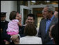 President George W. Bush smiles as Polish President Lech Kaczynski holds his granddaughter Ewa, Friday, June 8, 2007, at the Polish presidential seaside retreat in Jurata, Poland. White House photo by Eric Draper