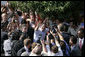 President George W. Bush waves as he's surrounded by townspeople and media Sunday, June 10, 2007, during his visit to Fushe Kruje, Albania. White House photo by Shealah Craighead