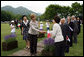 Mrs. Laura Bush, accompanied by Mrs. Kiyoko Fukuda, spouse of the Prime Minister of Japan, left, is greeted as she arrives to the Toyako New Mount Showa Memorial Park for a ceremonial tree planting ceremony with other G-8 spouses Wednesday, July 9, 2008, in Hokkaido, Japan. White House photo by Shealah Craighead