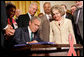 President George W. Bush is joined by Annette Lantos, right, and invited guests Wednesday, July 30, 2008 in the East Room of the White House, as he signs H.R. 5501, the Tom Lantos and Henry J. Hyde United States Global Leadership Against HIV/AIDS, Tuberculosis and Malaria Reauthorization Act of 2008. White House photo by Joyce N. Boghosian