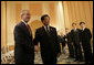 President George W. Bush is greeted by President Hu Jintao of China at the Hanoi Daewoo Hotel in Hanoi after his arrival Sunday, Nov. 19, 2006, for bilateral talks. President Bush told President Hu, "China is a very important nation, and the United States believes strongly that by working together, we can help solve problems." White House photo by Eric Draper