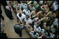 President George W. Bush is seen reaching into a crowd of military personnel to shake hands following his remarks at a breakfast meeting with U.S. military troops at Hickam Air Force Base, Tuesday. Nov. 21, 2006 in Honolulu, Hawaii. White House photo by Paul Morse