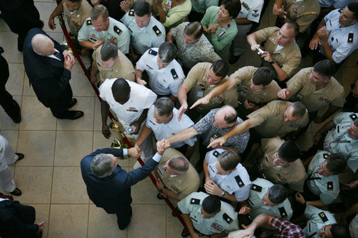 President George W. Bush is seen reaching into a crowd of military personnel to shake hands following his remarks at a breakfast meeting with U.S. military troops at Hickam Air Force Base, Tuesday. Nov. 21, 2006 in Honolulu, Hawaii. White House photo by Paul Morse
