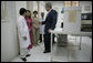 President George W. Bush and Mrs. Laura Bush are briefed as they tour the Pasteur Institute in Ho Chi Minh City Monday, Nov. 20, 2006. 