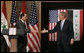 President George W. Bush reaches out to Iraqi Prime Minister Nouri al-Maliki Thursday, Nov. 30, 2006, following a joint press availability in Amman, Jordan. White House photo by Paul Morse