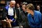 Laura Bush looks at an Ancient Thesis of Montichelli during a tour given by Paolo Novaria, Archives, left, at the University of Turin Saturday, Feb. 11, 2006, in Turin, Italy. White House photo by Shealah Craighead