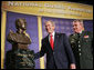 President George W. Bush admires a bust of himself presented in his honor Thursday, Feb. 9, 2006 at the National Guard Memorial Building in Washington, where President Bush talked about the global war on terror. White House photo by Paul Morse