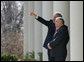 President George W. Bush shows Poland's President Lech Kaczynski points of interest around the White House from the Rose Garden steps outside the Oval Office, Thursday, Feb. 9, 2006 in Washington. White House photo by Eric Draper