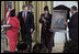 Proclaiming a holiday in honor of Martin Luther King, Jr., President George W. Bush receives a portrait of the civil rights leader from his wife and children in the East Room Jan. 21, 2002. Photographed from left to right are Coretta Scott King, the President, Rev. Bernice King and Martin Luther King III.