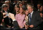 President George W. Bush takes a moment to pose for a picture with audience members Wednesday, Feb. 15, 2006 at Wendy's International, Inc. corporate headquarters in Dublin, Ohio, following his remarks on health care, and his commitment to help all Americans gain access to affordable, high-quality health care. White House photo by Paul Morse