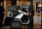 President George W. Bush looks over a scooter powered by solid hydrogen fuel during a demonstration of energy technologies at The National Building Museum in Washington, D.C., Thursday, Feb. 6, 2003. "Cars that will run on hydrogen fuel produce only water, not exhaust fumes," said the President in his remarks. "If we develop hydrogen power to its full potential, we can reduce our demand for oil by over 11 million barrels per day by the year 2040." White House photo by Paul Morse.