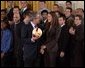 President George W. Bush talks with Lauren Killian, captain of the women's volleyball team at University of Southern California, during a visit by the NCAA Fall Champions to the East Room Monday, Feb. 24, 2003. White House photo by Tina Hager