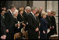 President George W. Bush and Laura Bush stand during the State Funeral for former President Gerald R. Ford at the National Cathedral in Washington, D.C., January 2, 2007. Standing back row left, former President George H.W. Bush, former first lady Barbara Bush, Dora Bush Koch, and former President Bill Clinton. Front row, left to right, Mrs. Lynne Cheney, former President Jimmy Carter, former first lady Rosalynn Carter, and former first lady Nancy Reagan White House photo by Eric Draper