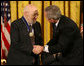 President George W. Bush congratulates Dr. Joshua Lederberg after presenting him with the 2006 Presidential Medal of Freedom Friday, Dec. 15, 2006, during ceremonies at the White House. Said the President, "Joshua Lederberg has always seemed ahead of his time. For his brilliant career, his high ethical standards, and his many contributions to our country, the United States thanks Dr. Joshua Lederberg." White House photo by Eric Draper