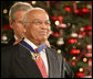 Dr. Norman C. Francis is honored by President George W. Bush with the Presidential Medal of Freedom Friday, Dec. 15, 2006, in the East Room of the White House. President Bush told the audience, "Dr. Francis is known across Louisiana, and throughout our country, as a man of deep intellect and compassion and character. All of us admire the good life and remarkable career of Dr. Norman C. Francis." White House photo by Shealah Craighead