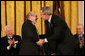 President George W. Bush congratulates Natan Sharansky after honoring him with the 2006 Presidential Medal of Freedom during ceremonies Friday, Dec. 15, 2006, at the White House. Said the President, "Americans first came to know Natan Sharansky as a voice for freedom inside an empire of tyranny. As a free man, he's become a political leader in Israel. He remains, above all, an eloquent champion for liberty and democracy. We honor Natan Sharansky for his life of courage and conviction." White House photo by Eric Draper