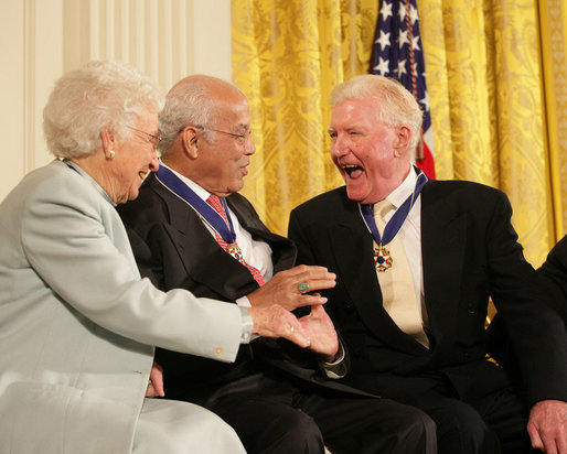 Author Paul Johnson is congratulated by Dr. Norman C. Francis and Ruth Johnson Colvin after receiving his Presidential Medal of Freedom from President George W. Bush Friday, Dec. 15, 2006, during ceremonies in the East Room of the White House. In honoring Mr. Johnson, President Bush said, "Our country honors Paul Johnson, and proudly calls him a friend." White House photo by Shealah Craighead