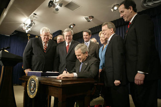 President George W. Bush signs H.R. 6111, the Tax Relief and Health Care Act of 2006, in the Dwight D. Eisenhower Executive Office Building, Dec. 20, 2006. Pictured with the President are, from left: Speaker Dennis Hastert, Sen. Bill Frist, R-Tenn., obscured, Sen. Pete Domenici, R-N.M., obscured, Rep. Bill Thomas, R-Calif., Sen. David Vitter, R-La., Secretary of the Interior, Dirk Kempthorne, obscured, Sen. Mary Landrieu, D-La., Sen. Mike DeWine, R-Ohio and Sen. Rick Santorum, R-Pa. White House photo by Kimberlee Hewitt