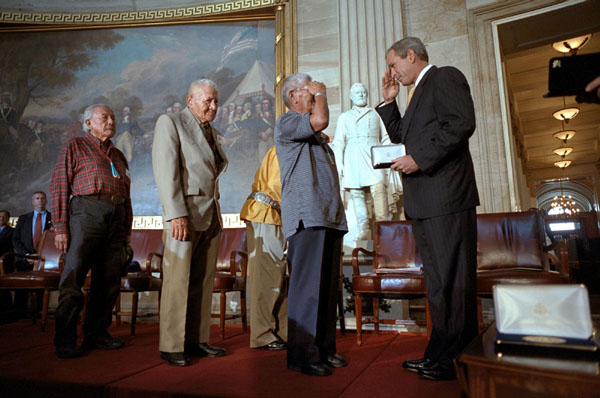 President George W. Bush presents medals to 21 Navajo Code Talkers during a ceremony honoring their military service at the U.S. Capitol July 26. During World War II, the Code Talkers used their native language as an unbreakable code to relay secret messages. White House photo by Paul Morse.