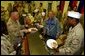 President George W. Bush meets with troops and serves Thanksgiving Dinner at the Bob Hope Dining Facility, Baghdad International Airport, Iraq,, Thursday, November 27, 2003. White House photo by Tina Hager.