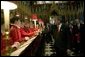 After listening to the Westminster Abbey Choir perform, President George W. Bush greets one of the younger choir members during his and Mrs. Bush's tour of the abbey Thursday, Nov. 20, 2003. White House photo by Eric Draper.