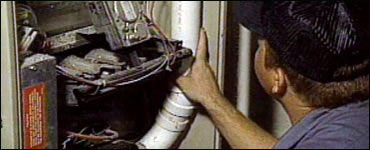 Photo: Qualified technician inspecting heating system