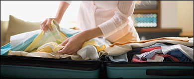 A woman packing a suitcase