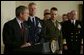 President George W. Bush speaks at the Pentagon Tuesday, March 25, 2003. Also pictured, from left, are Chairman of the Joint Chiefs of Staff General Richard B. Myers, Vice Chairman of the Joint Chiefs of Staff General Peter Pace and Chief of Naval Operations Admiral Vern Clark. White House photo by Paul Morse.