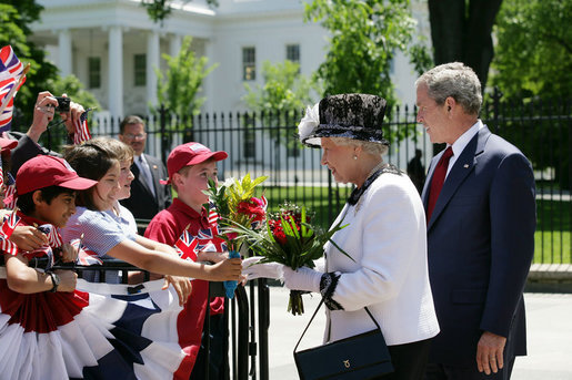 President George W. Bush and Her Majesty Queen Elizabeth II of Great Britain stop to meet a group of children offering flowers Monday, May 7, 2007, during their walk from the White House to Blair House, where the Queen Elizabeth II and His Royal Highness the Prince Philip, Duke of Edinburgh, are staying during their visit to Washington, D.C. White House photo by Eric Draper