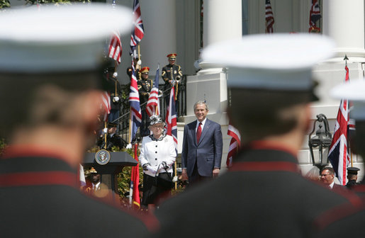 President George W. Bush and Her Majesty Queen Elizabeth II of Great Britain are framed between troops on review Monday, May 7, 2007, at the state arrival ceremony on the South Lawn of the White House. White House photo by Joyce Boghosian