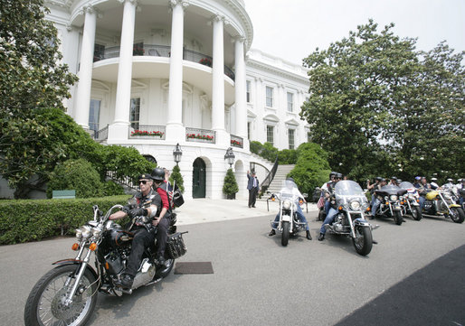 President George W. Bush bids farewell to members of the Rolling Thunder motorcycle organization, as they drive away from the South Portico of the White House following their visit Sunday, May 27, 2007. Rolling Thunder, founded by a group of Vietnam veterans in 1987, marks its 20th year of supporting U.S. troops overseas, at home and missing in action. White House photo by Joyce Boghosian