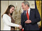 President George W. Bush congratulates military spouse Linda Port of Langley Air Force Base, Va., as she is presented with the President’s Volunteer Service Award Friday, May 11, 2007, in the East Room of the White House during a celebration of Military Spouse Day. White House photo by Eric Draper