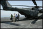 USS John C. Stennis Strike Group Commander Rear Admiral Kevin Quinn greets Vice President Dick Cheney and his daughter Liz Cheney, left, upon their arrival, Friday, May 11, 2007, to the aircraft carrier John C. Stennis in the Persian Gulf. White House photo by David Bohrer