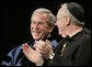 President George W. Bush, sitting with Saint Vincent College Archabbot and Chancellor Rev. Douglas Nowicki, is applauded prior to being introduced Friday, May 11, 2007, to deliver the commencement address to graduates at Saint Vincent College in Latrobe, Pa. White House photo by Joyce Boghosian