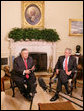 President George W. Bush listens as President Jalal Talabani of Iraq addresses members of the media in the Oval Office Thursday, May 31, 2007. White House photo by Eric Draper