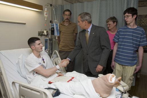 President George W. Bush shakes the hand of Cpl. Ryan T. Dion of Manchester, Conn., after awarding him a Purple Heart Thursday, May 25, 2007, during a visit to the National Naval Medical Center in Bethesda, Md., where the Marine is recovering from wounds received in Operation Iraqi Freedom. With them are Cpl. Dion's parents, Thomas and Patricia Dion, and brother, Justin. White House photo by Joyce Boghosian