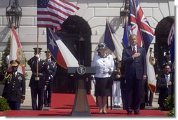 President George W. Bush stands with his hand over his heart during the playing of America's national anthem during the Arrival Ceremony for Her Majesty Queen Elizabeth II and His Royal Highness The Prince Philip Duke of Edinburgh Monday, May 7, 2007, on the South Lawn.  White House photo by Lynden Steele