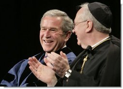 President George W. Bush, sitting with Saint Vincent College Archabbot and Chancellor Rev. Douglas Nowicki, is applauded prior to being introduced Friday, May 11, 2007, to deliver the commencement address to graduates at Saint Vincent College in Latrobe, Pa. White House photo by Joyce N. Boghosian
