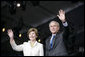 President George W. Bush and Mrs. Laura Bush wave Sunday, May 13, 2007, as they arrive at Anniversary Park in Williamsburg, Va., where the President delivered a speech in celebration of the 400th anniversary of the Jamestown Settlement. "Today we have no closer ally than the nation we once fought for our independence," said the President. "Britain and American are united by our democratic heritage, and by the history that began at this settlement 400 years ago." White House photo by Shealah Craighead