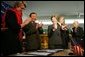 Laura Bush applauds as Secretary of Education Margaret Spellings and Afghan Minister of Education Noor Mohammas Qarqeen complete the signing of the Memorandum of Understanding for funds to build a university in Kabul, Afghanistan Wednesday, March 30, 2005. White House photo by Susan Sterner