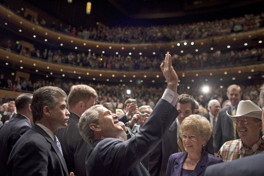 President George W. Bush waves to people in the balconies after participating in a conversation on strengthening Social Security at the Cannon Center for the Performing Arts in Memphis, Tenn., Friday, March 11, 2005. White House photo by Paul Morse