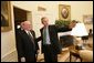 President George W. Bush talks with U.S. Army veteran Tom Cadmus, the National Commander of the American Legion, in the Oval Office Thursday, March 17, 2005. White House photo by Eric Draper